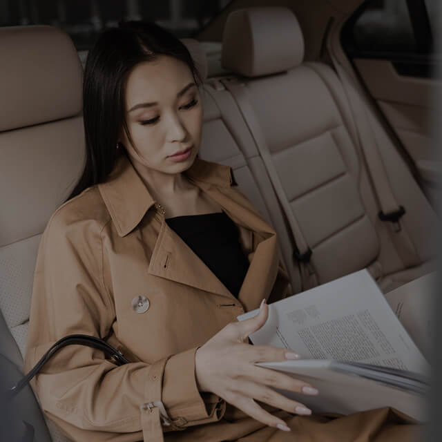 girl reading papers inside a car